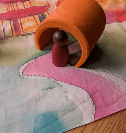 Close-up of Lunar Lanterns Story Scarf, showing the a wooden peg doll and arch