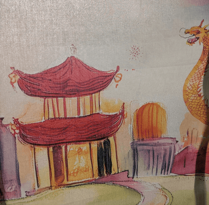 Close-up of the soft Pima cotton fabric of the Lunar Lanterns Story Scarf, showing the dragon illustration.